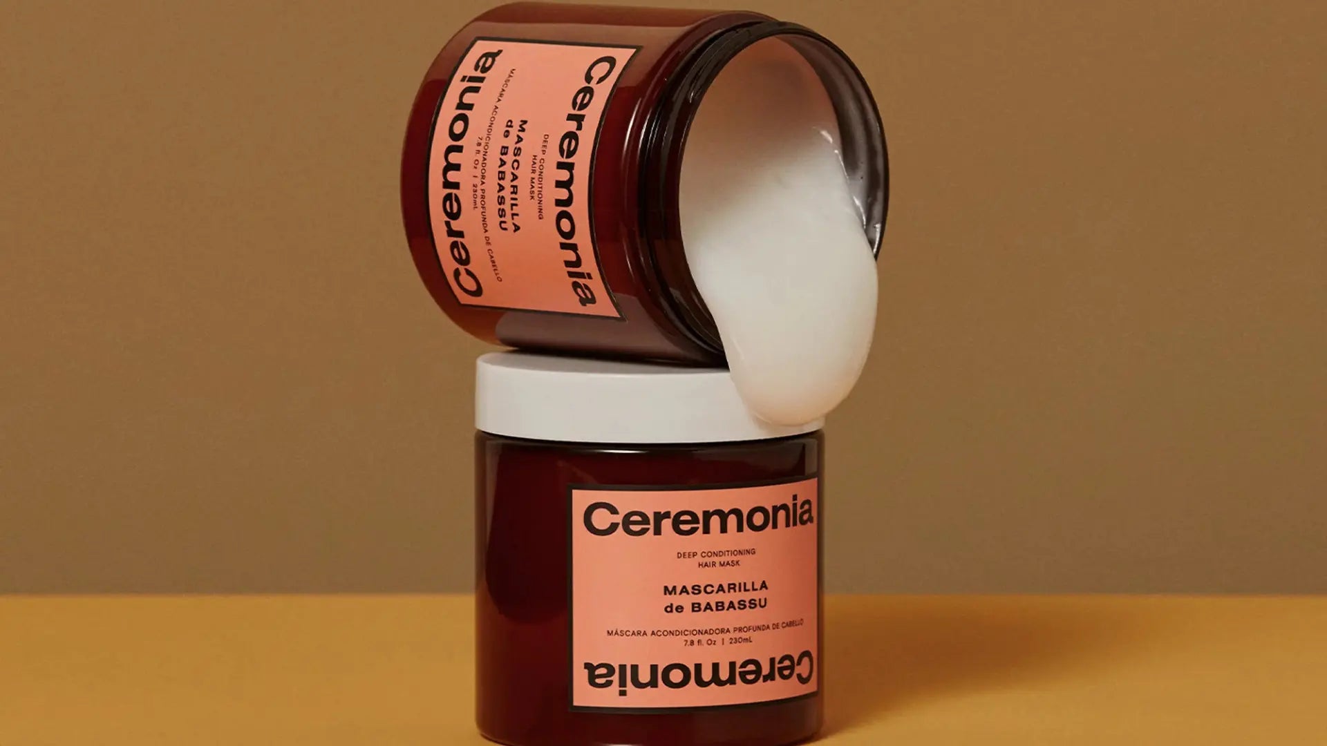 Two stacked jars of Ceremonia's Mascarilla de Babassu nourishing hair mask, one open to reveal its creamy white formula.