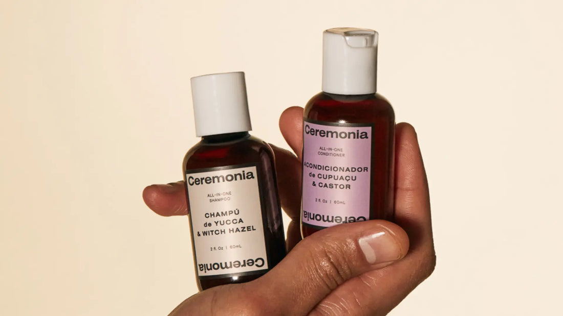 Hydrating shampoo and conditioner from Ceremonia held in hand, featuring yucca and castor ingredients.