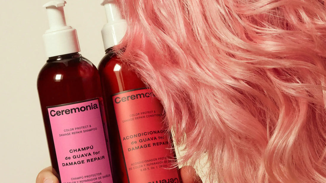Sulfate-free shampoo and conditioner from Ceremonia held next to soft, pastel pink hair.