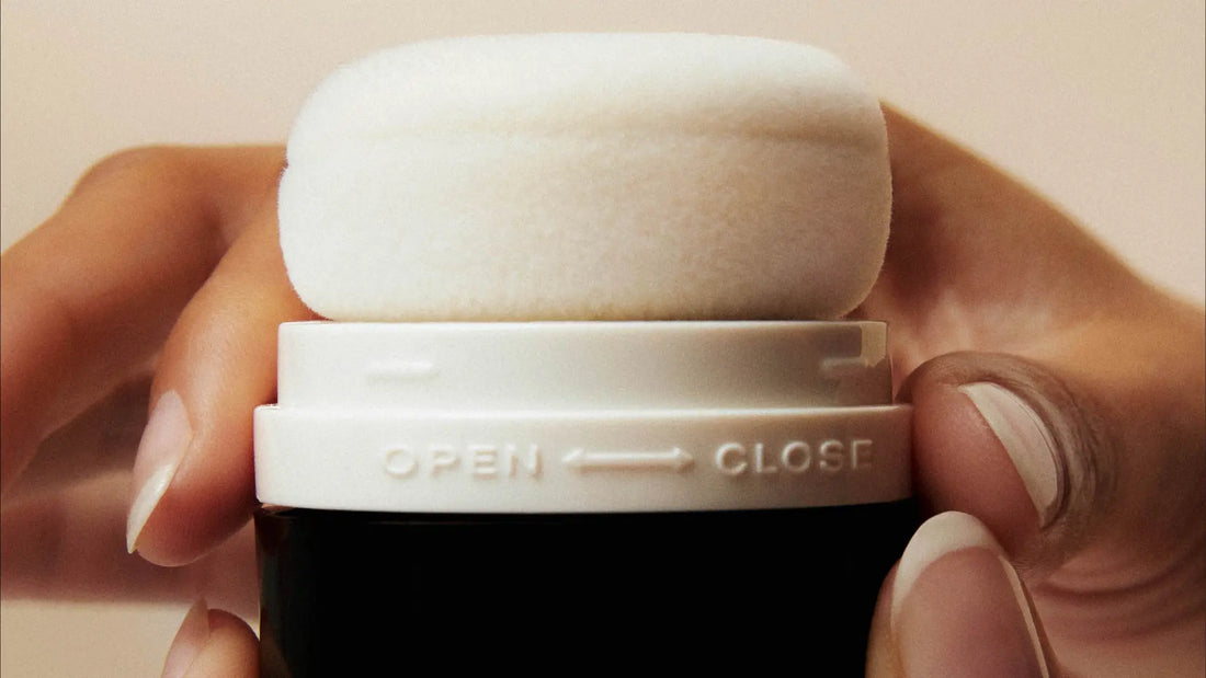 Talc-free dry shampoo applicator with a soft puff top designed for easy, mess-free powder application to refresh hair.