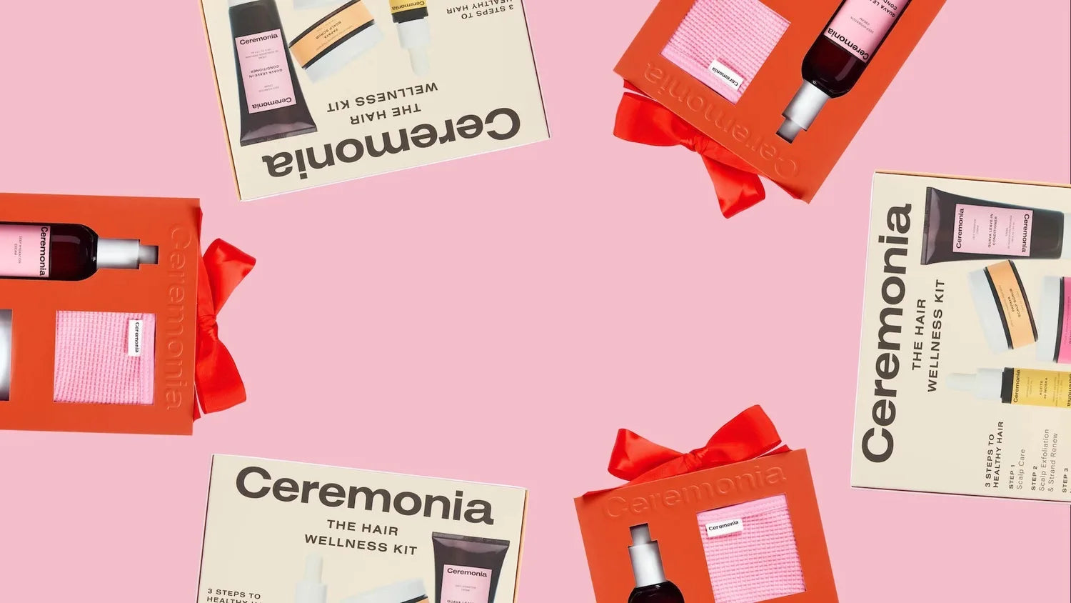Ceremonia Hair Wellness Kit gift sets with red bows arranged on a pink background.