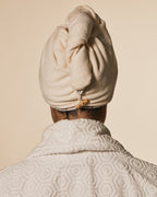Beige hair towel shown from the back with loop and button closure for easy wrap styling.