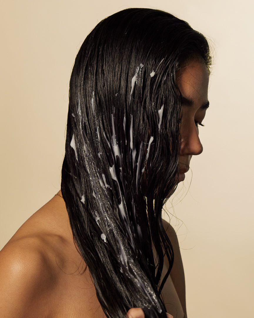 Wet dark hair coated in Deep Moisture cupuaçu conditioner during a hydrating wash day ritual.