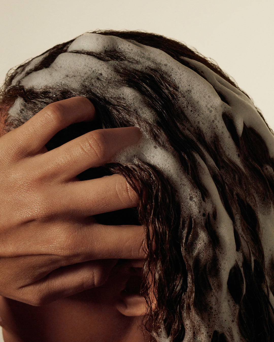 UV protection shampoo lathered on scalp and hair during cleansing.