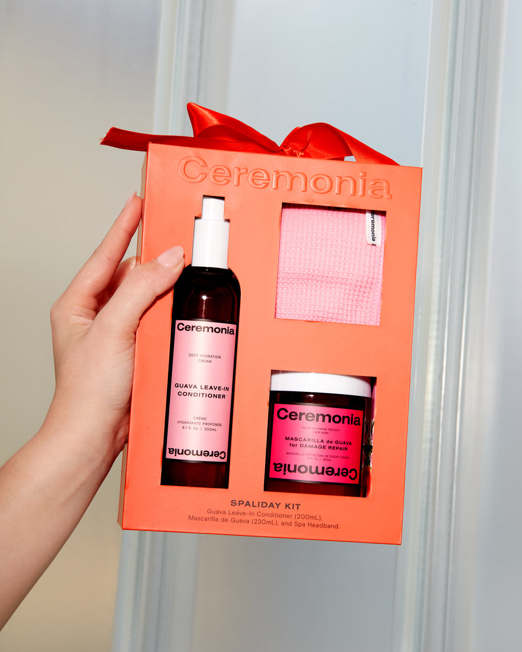 Guava leave-in conditioner featured in a Ceremonia Spaliday Kit alongside a guava hair mask and pink spa headband.