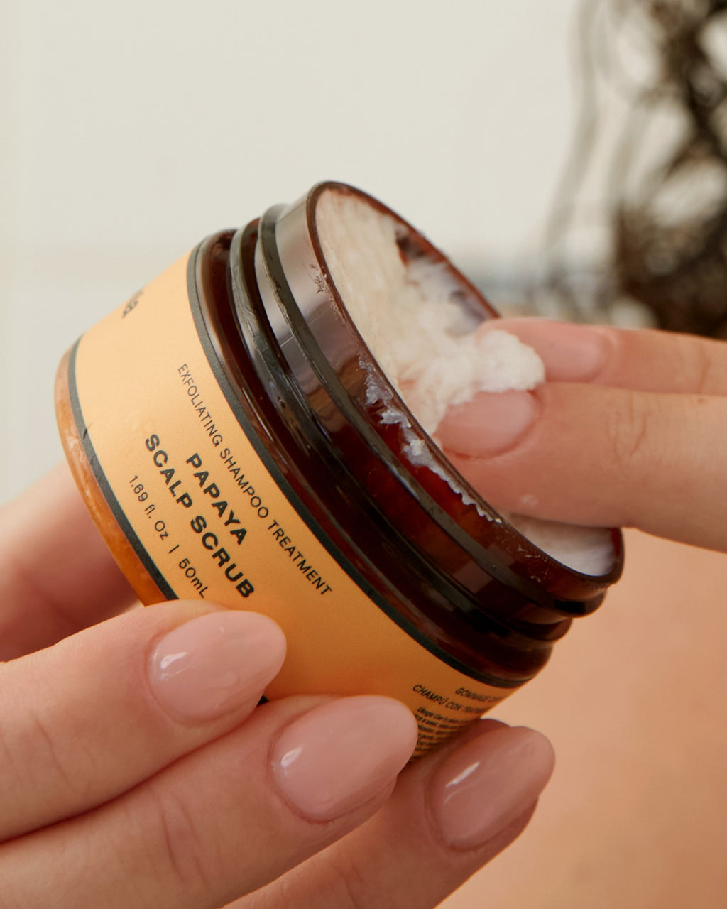 Exfoliating hair treatment shown as Ceremonia's Papaya Scalp Scrub, a creamy formula designed to deeply cleanse and revitalize the scalp.
