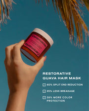 Guava hair mask jar held up against a sunny sky with palm leaves in the background.