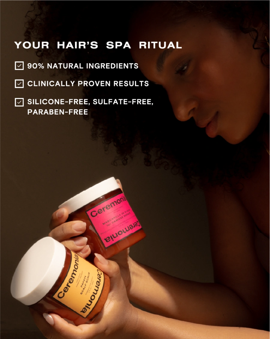 Papaya scalp scrub and guava hair mask jars held in a self-care ritual with natural lighting.