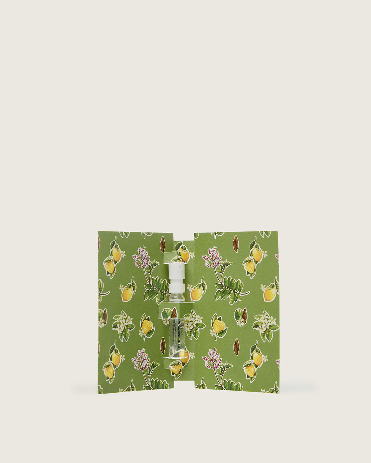 Perfume sample in a floral green cardholder with lemon and botanical print.
