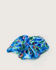Blue scrunchie with a vibrant passionfruit pattern from Ceremonia displayed against a plain white background.