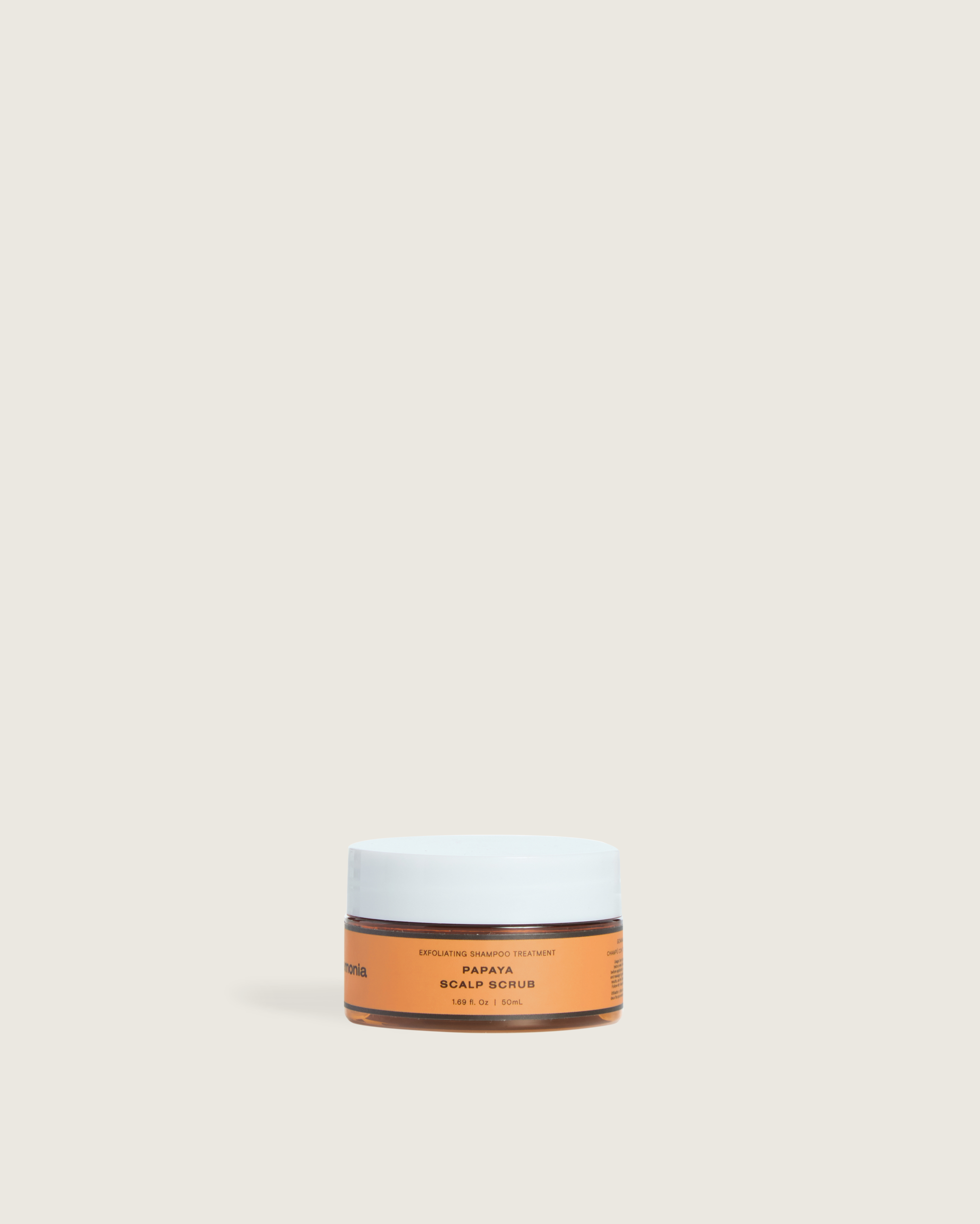 Papaya scalp scrub in a travel-size Ceremonia jar designed for exfoliating and cleansing the scalp.