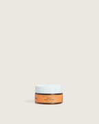 Papaya scalp scrub in a travel-size Ceremonia jar designed for exfoliating and cleansing the scalp.