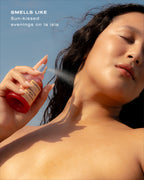 Guava perfume mist being sprayed onto neck by a glowing woman under the sun with text describing a sun-kissed scent.