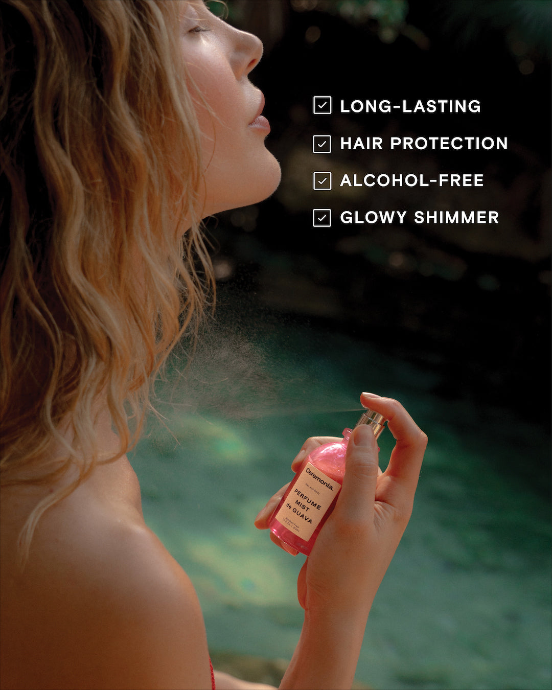 A women spritzing herself with a pink bottle of perfume with a tan label on the bottle that says "Perfume Mist de Guava" in black text. A list in the top right corner has checkboxes. In front of those textboxes it reads, Long-Lasting, Hair Protection, Alcohol-Free, Glowy Shimmer. 
