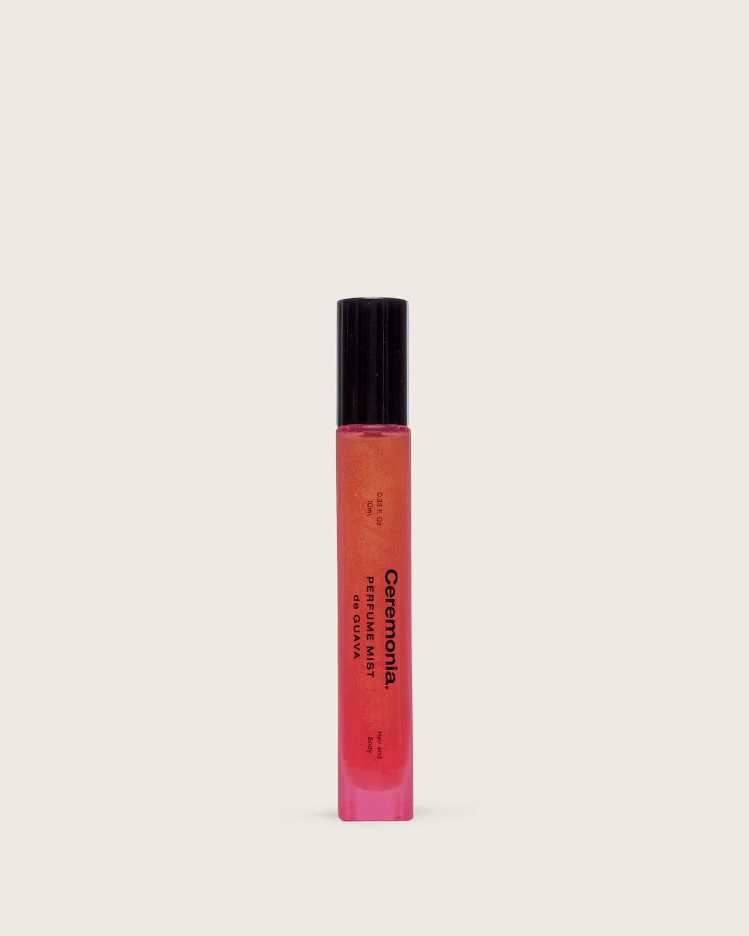 Perfume mist de Guava in a slim pink shimmer bottle with black cap, displayed on a light neutral background.