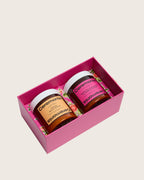 Papaya scalp scrub and guava hair mask duo in a vibrant pink gift box.