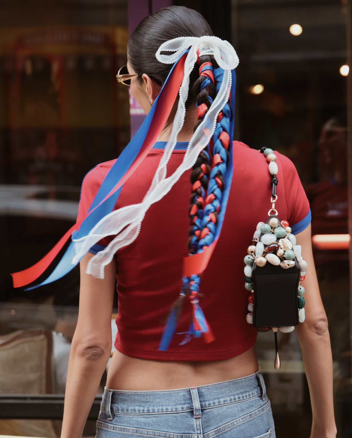 Woman with braids in different color ribbons.