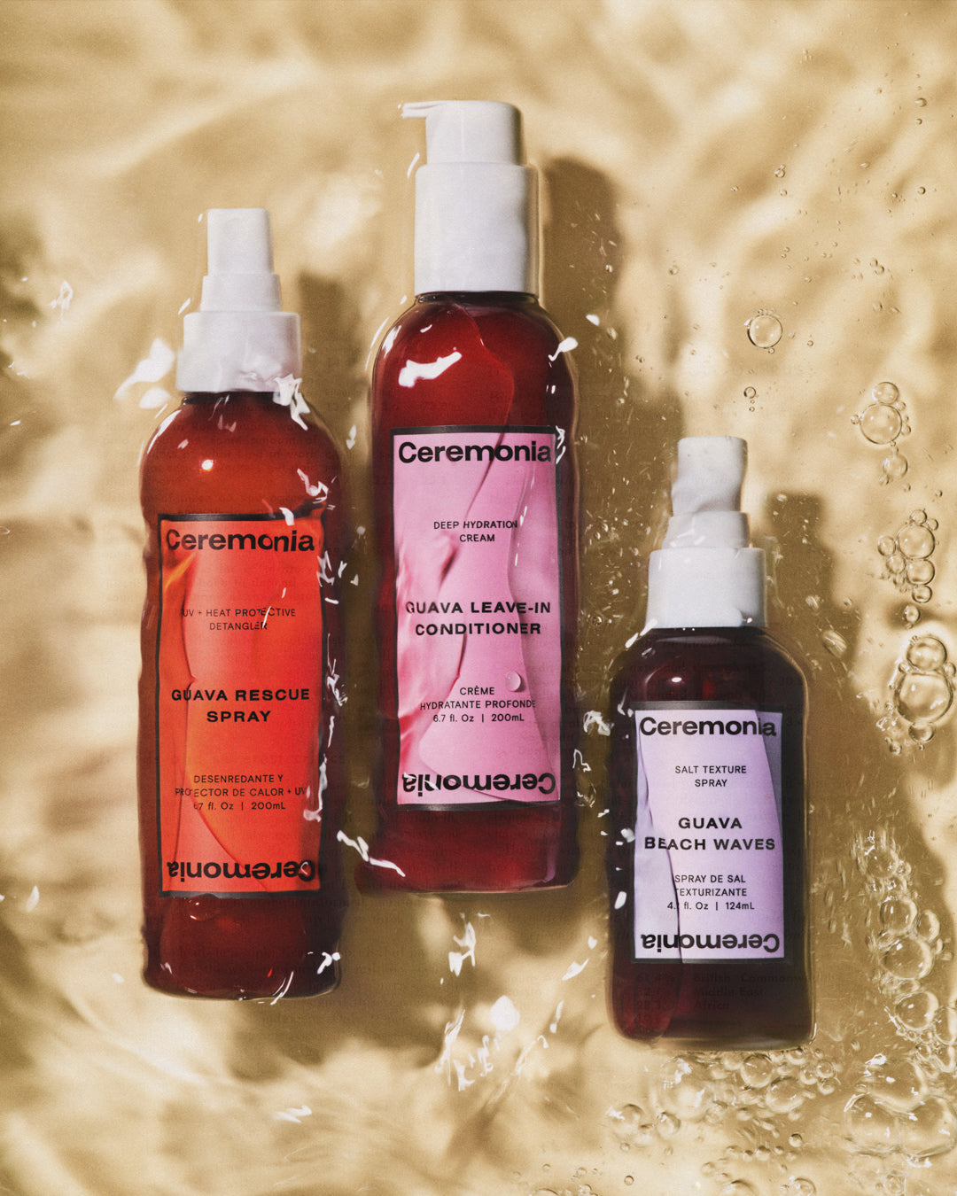 Guava Beach Waves salt texture spray beside Ceremonia rescue spray and leave-in conditioner on rippled water.