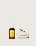Ceremonia Aceite de Moska scalp oil dropper bottle beside a cream silicone scalp massager.