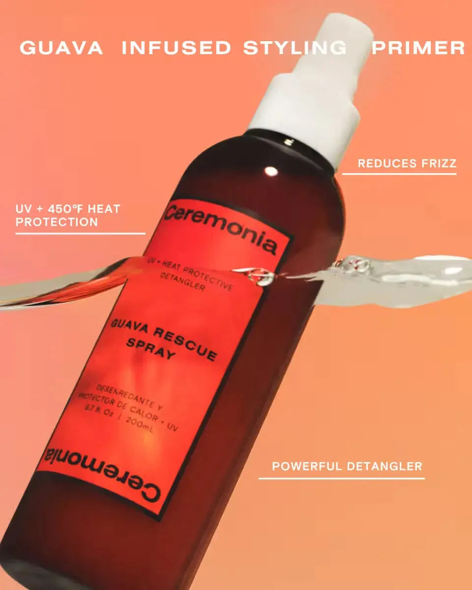 Hair detangler spray bottle mid-splash, highlighting UV and heat protection with guava-infused formula.