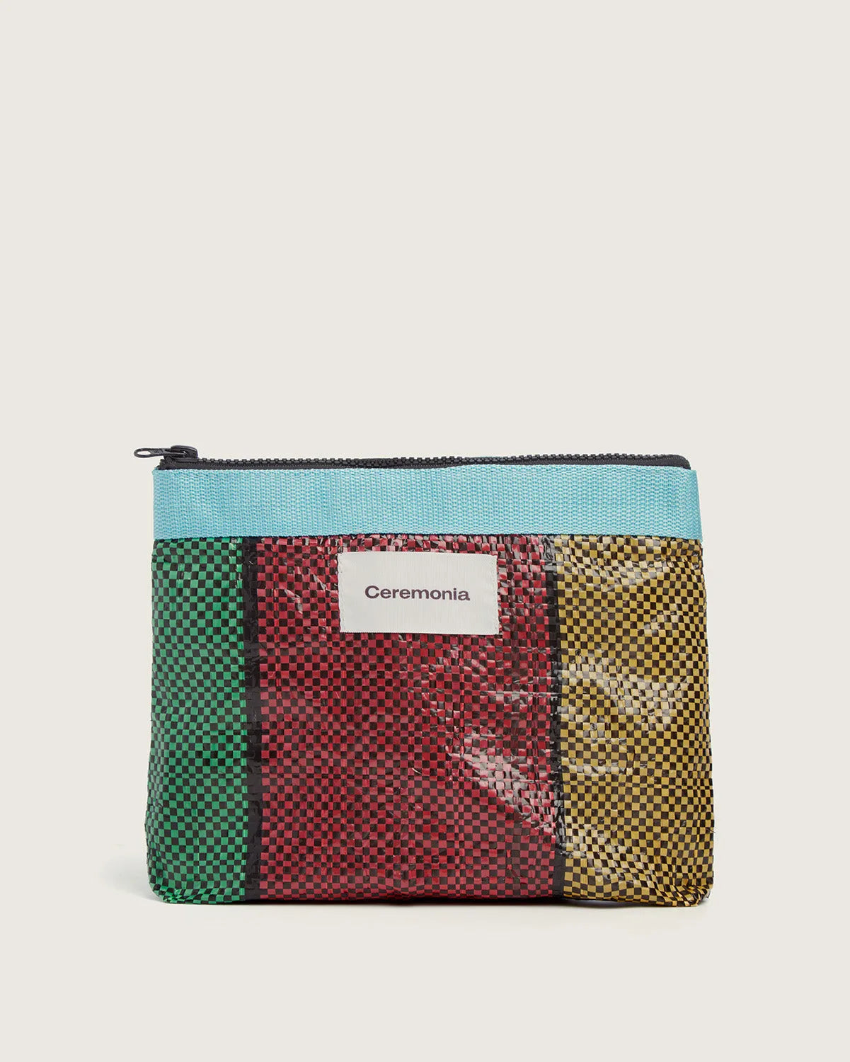 Handmade Pouch de Mercado in green, red, and yellow woven upcycled polypropylene with blue zipper.