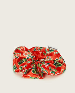 Oversized red satin Ceremonia scrunchie in guava fruit and floral print with brand tag.