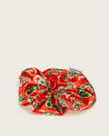 Oversized red satin Ceremonia scrunchie in guava fruit and floral print with brand tag.
