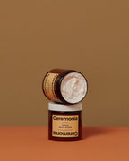 Two stacked amber jars of Ceremonia Papaya Scalp Scrub, one open showing whipped exfoliating shampoo.