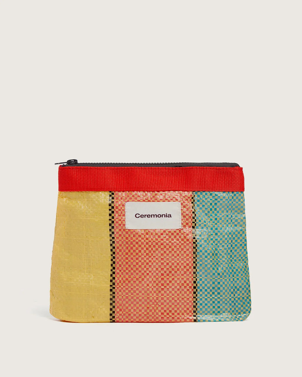 Upcycled woven Pouch de Mercado in yellow, coral, and blue stripes with red zipper trim.