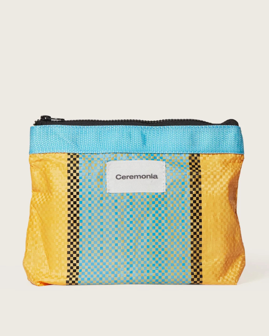 Yellow and blue woven Ceremonia Pouch de Mercado made from upcycled Colombian market materials.