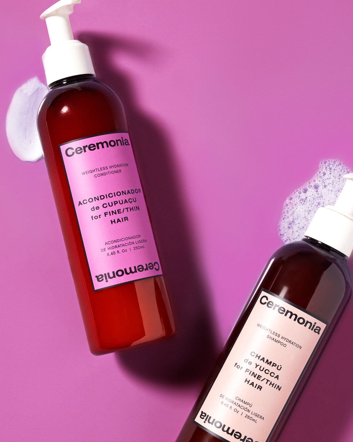 Ceremonia Weightless Hydration shampoo and conditioner for fine hair beside foam and cream swatches on magenta.