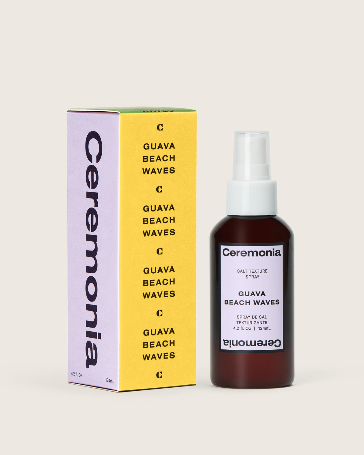 Ceremonia Guava Beach Waves salt texture spray bottle beside its yellow and lilac carton.